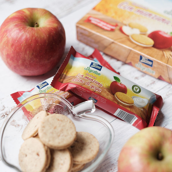 Tirma Digestive Apple Biscuit Filled with Yogurt Cream  next to the 2 apples and apple shaped bowl filled with apple biscuits. Spanish apple biscuits made in Spain