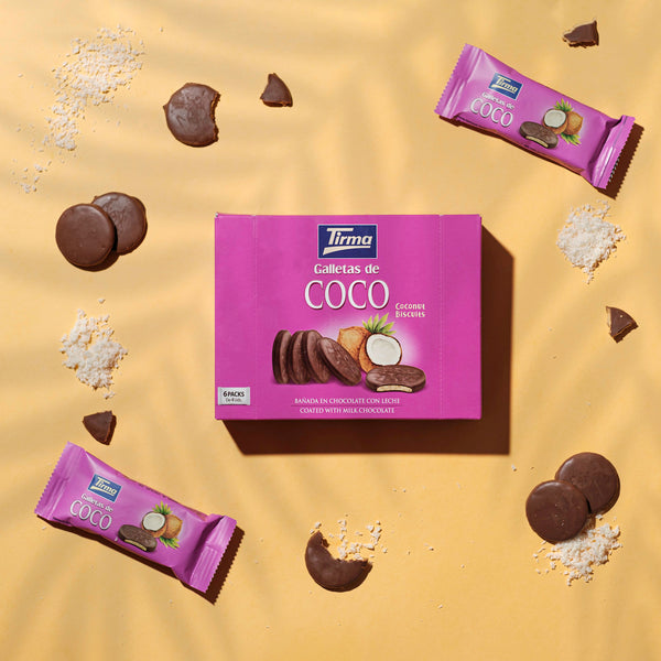 Coconut Biscuit covered in Milk Chocolate 200 g with 2 biscuits outside the box with scattered coconut pulp next to biscuits. Spanish coconut biscuits made in Spain.