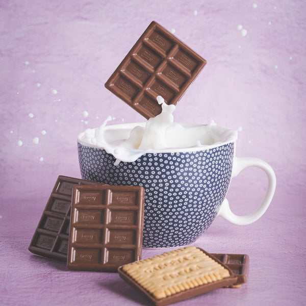 Tirma Biscuits with Milk Chocolate 160 g - showing of 4 milk chocolate and 1 biscuit with a chocolate falling in a cup of milk. Spanish milk chocolate biscuits made in Spain.