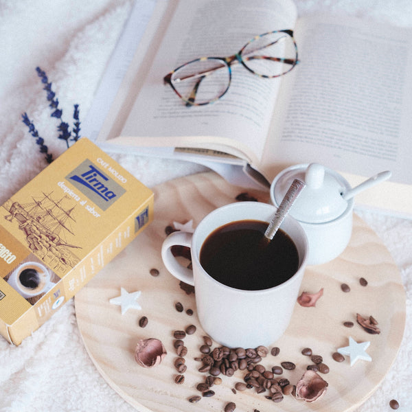 Tirma Torrefacto coffee, 250g placed next to sugar and a mug of coffee with spoon. Spanish Coffee made in Spain.