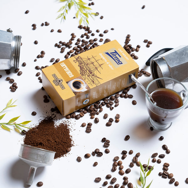 Tirma Torrefacto coffee, 250g placed next to scattered coffee bean and a mug of coffee with spoon. Spanish Coffee made in Spain.