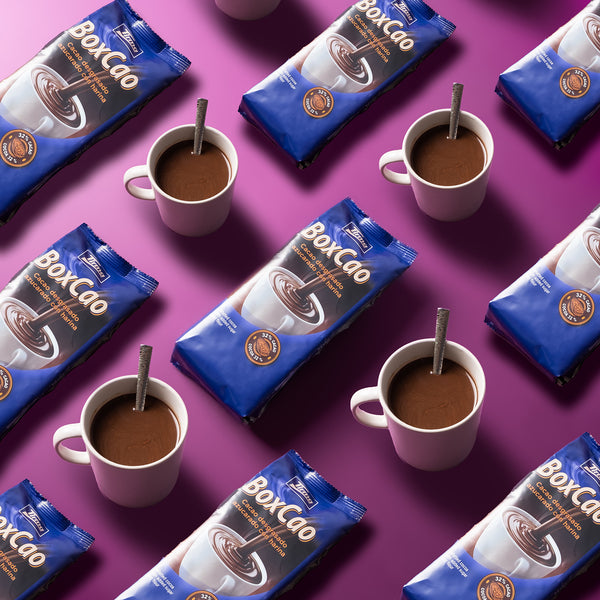 Tirma Spanish Thick Hot Chocolate Powder Non-GMO 400 g prepared in 4 cups on a pink background. Spanish chocolate powder made in Spain.