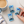 Hand holding a menthol candy with a cup of coffee on the table beside it
