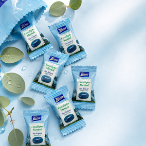 Individually wrapped menthol candies on a blue table