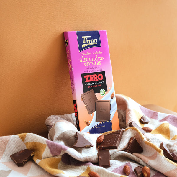 Tirma Milk Chocolate Bar with Whole Almonds, No Added Sugars, 125g. Gluten Free Chocolate Bar placed in an orange background. Spanish chocolate made in Spain.