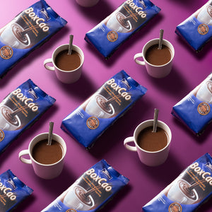 Tirma Spanish Thick Hot Chocolate Powder Non-GMO 400 g prepared in 4 cups on a pink background. Spanish chocolate powder made in Spain.