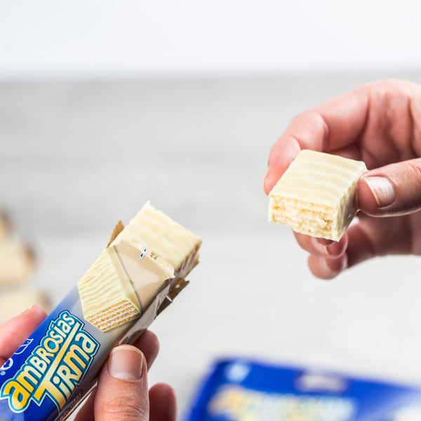 Tirma White Chocolate Wafers unwrapped and broken in half to display the wafer which is cream filled inside covered in white chocolate.